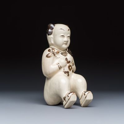 A Chinese Cizhou figure of a seated boy, probably Song