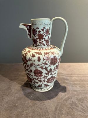 A Chinese copper-red and white 'flower scroll' ewer, Ming or later — photo 1