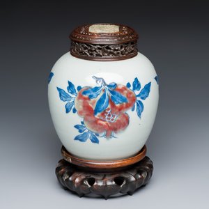 A Chinese copper-red, blue and white 'Fruits' jar with a jade-inset wooden cover and a stand — photo 1