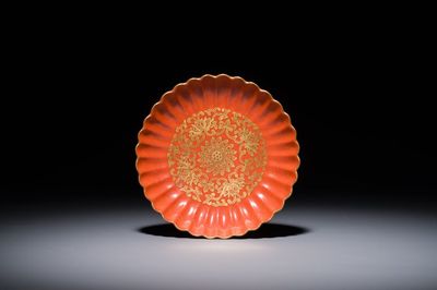A Chinese coral-red-glazed gilt-decorated 'lotus scroll' saucer, Jiaqing mark, Republic
