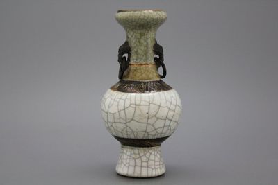A Chinese crackle glazed bottle vase with elephant handles, 19th C.