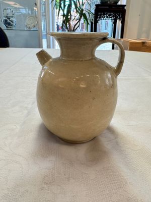 A Chinese cream-glazed ewer with a barrel-shaped body, Hebei/Henan provinces, Tang/Five Dynasties — photo 1