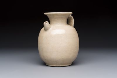 A Chinese cream-glazed ewer with a barrel-shaped body, Hebei/Henan provinces, Tang/Five Dynasties