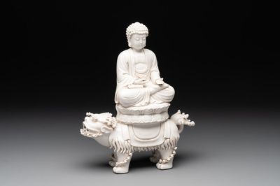 A Chinese Dehua blanc de Chine Buddha seated on a lion, 20th C.