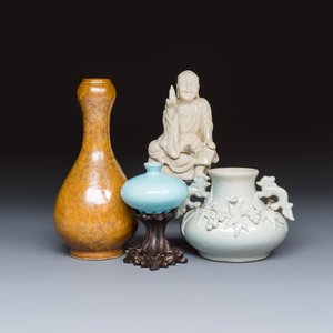 A Chinese Dehua blanc de Chine figure of Luohan and three monochrome wares, one with a wooden stand — photo 1