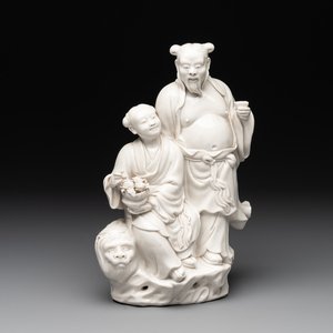 A Chinese Dehua blanc de Chine group of a man and a seated boy on a lion, 20th C. — 照片 1