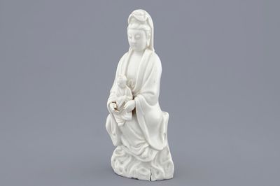 A Chinese Dehua blanc de Chine model of Guanyin with child, 19th C.