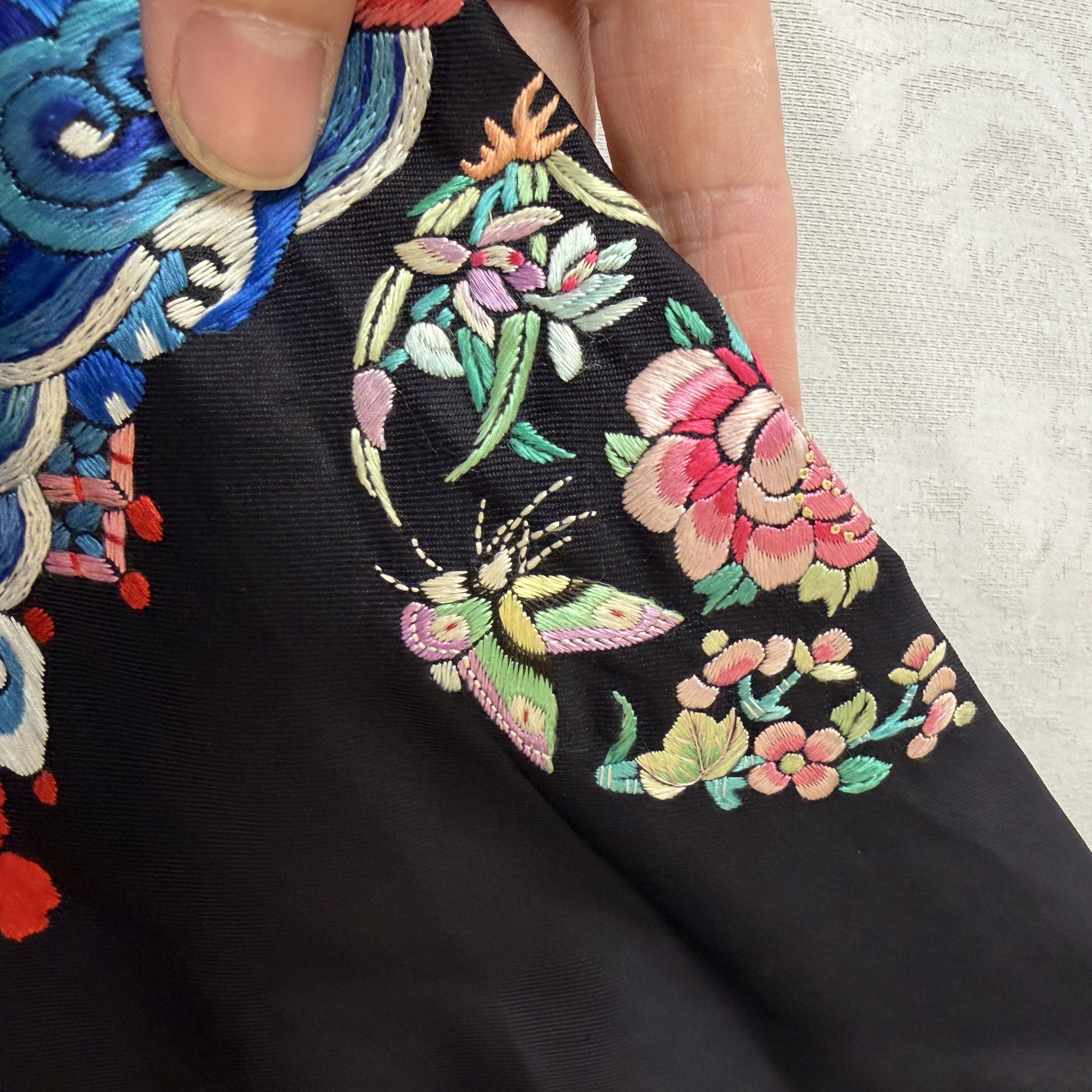 A Chinese embroidered silk dark-blue-ground robe with floral medallions — photo 10