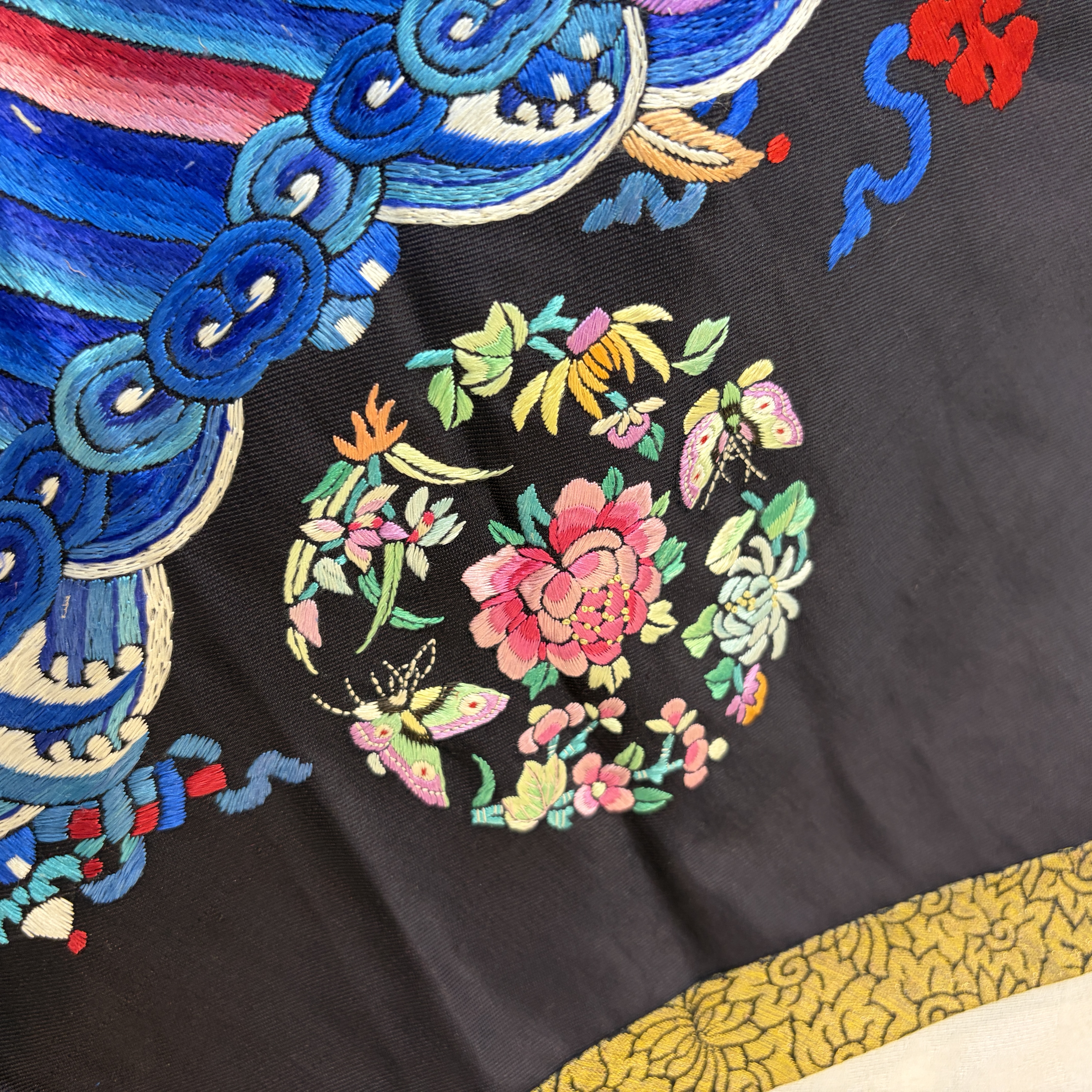 A Chinese embroidered silk dark-blue-ground robe with floral medallions — photo 11