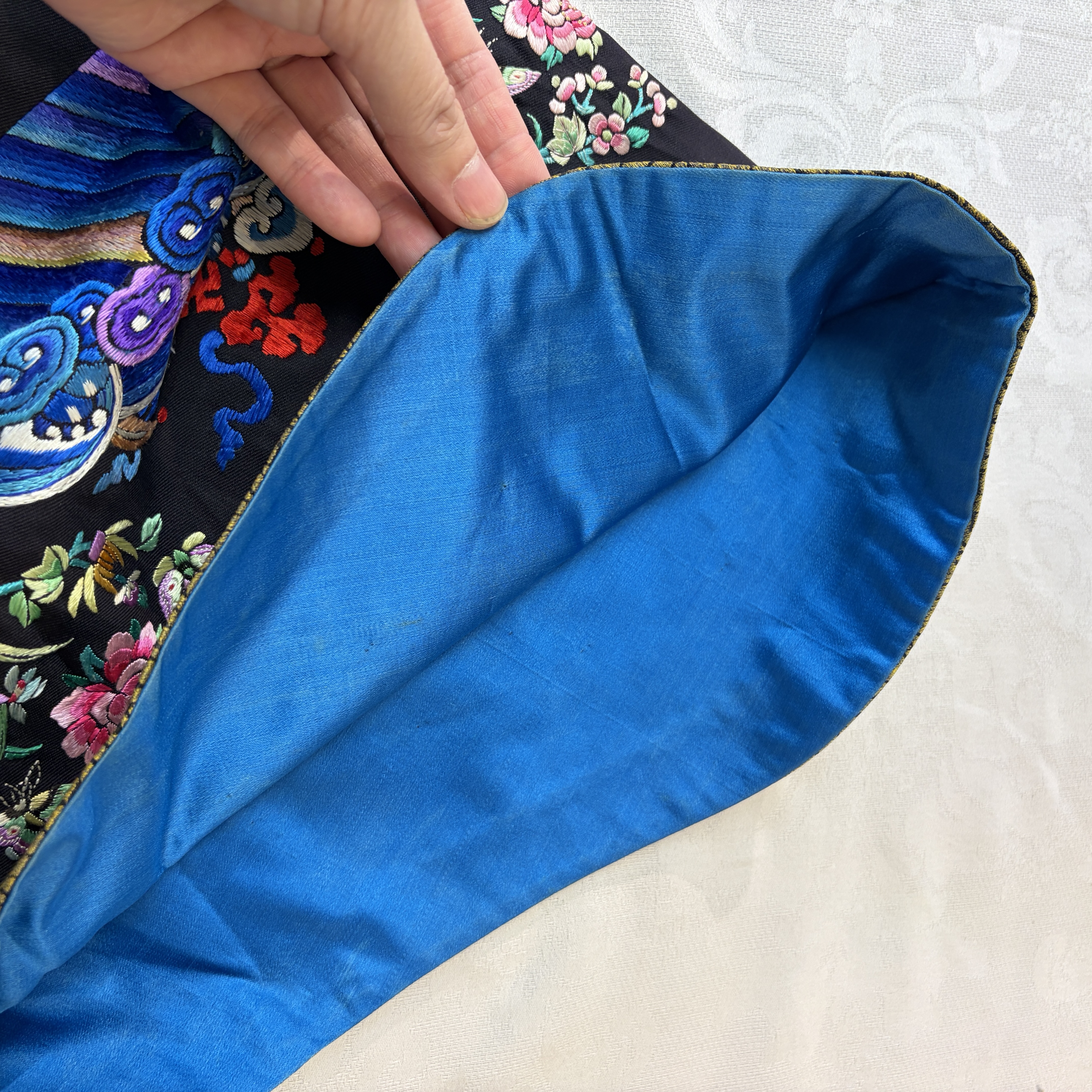 A Chinese embroidered silk dark-blue-ground robe with floral medallions — photo 13