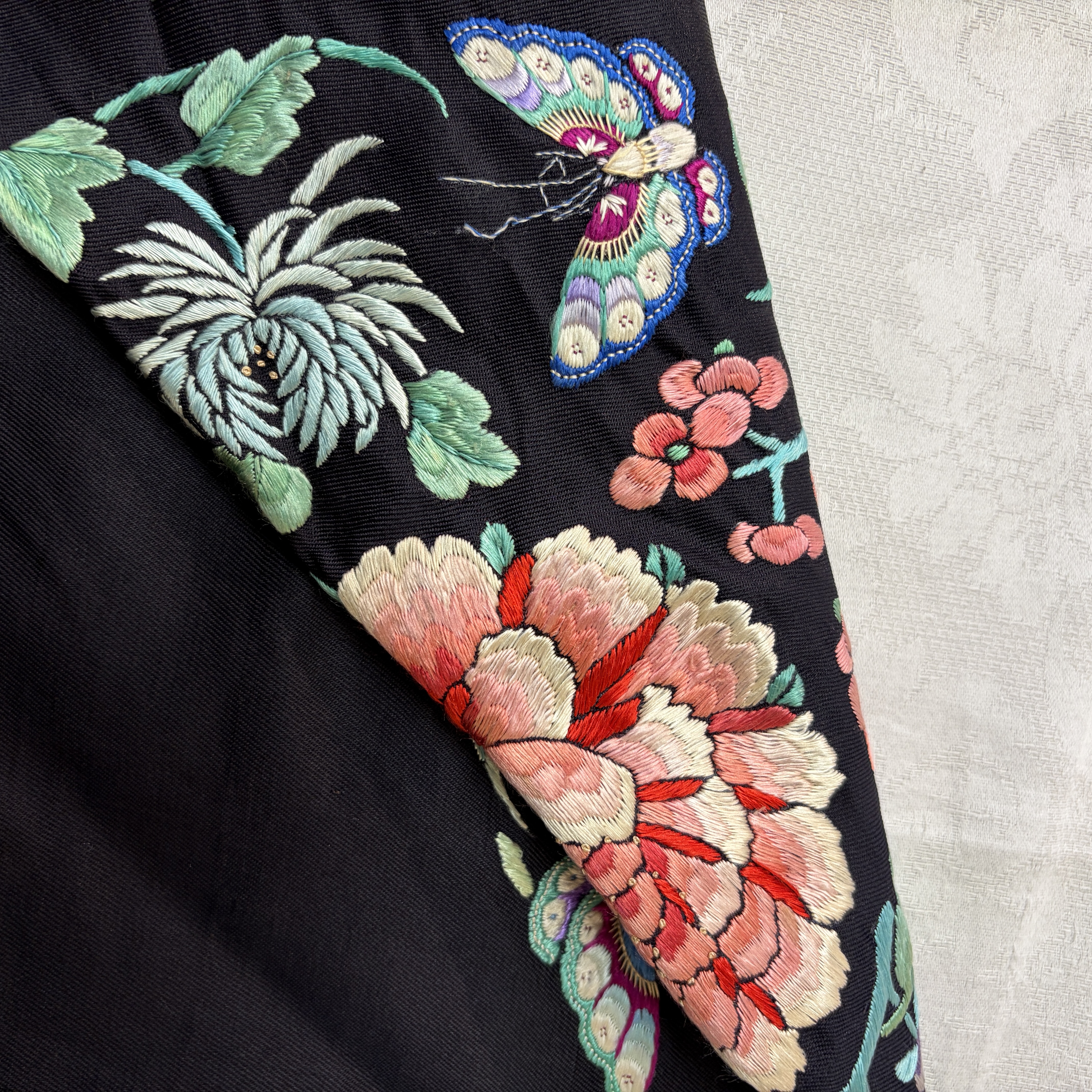 A Chinese embroidered silk dark-blue-ground robe with floral medallions — photo 15