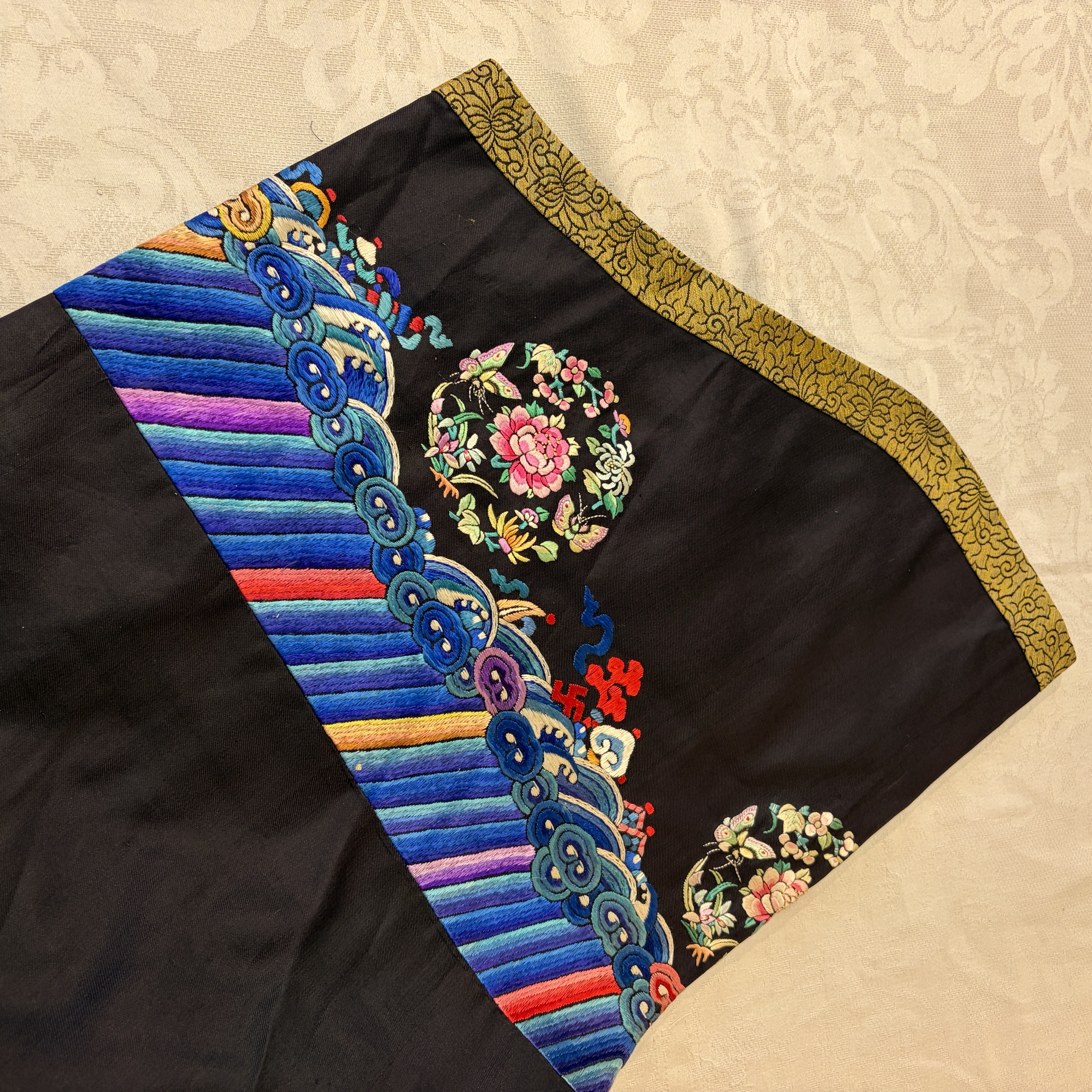 A Chinese embroidered silk dark-blue-ground robe with floral medallions — photo 16