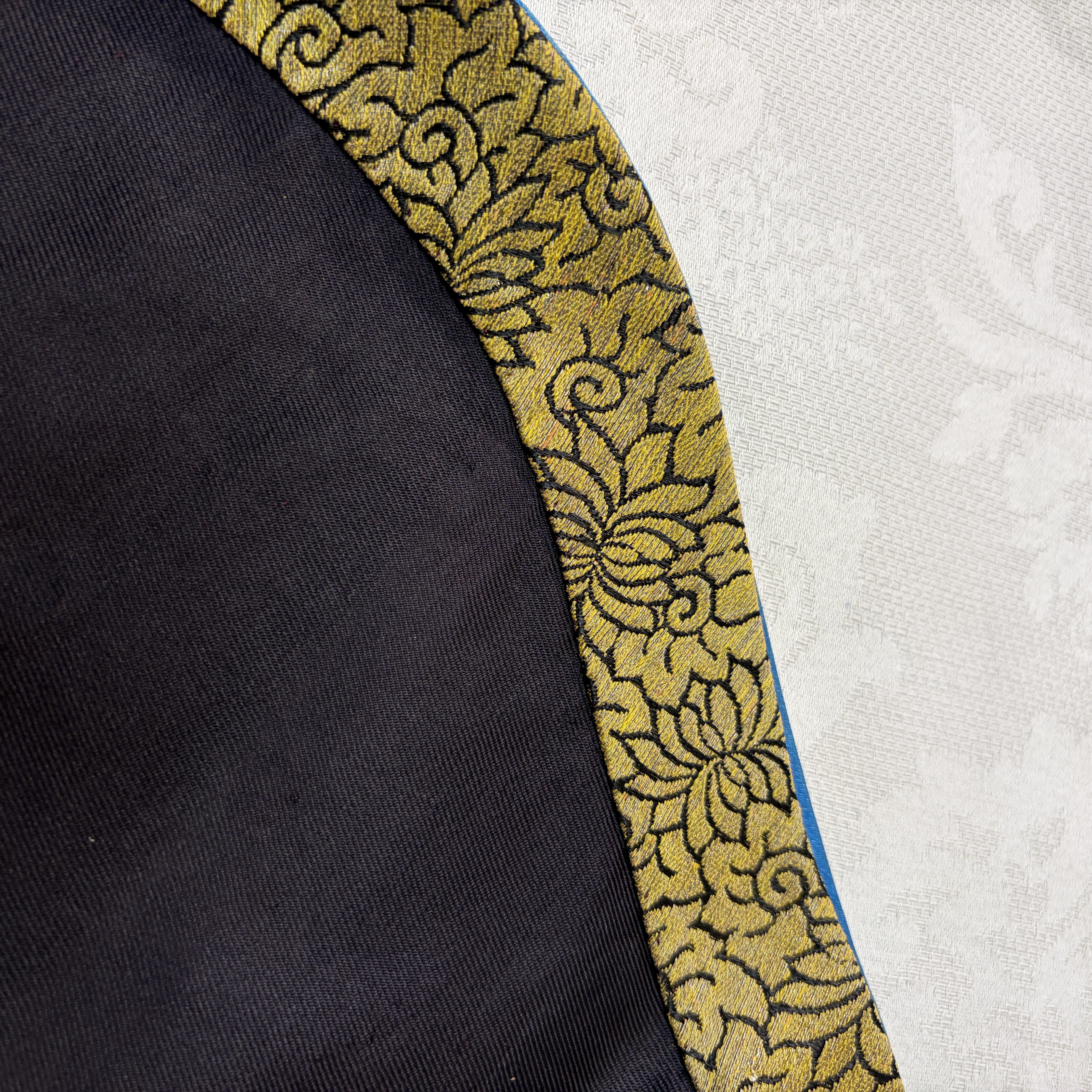 A Chinese embroidered silk dark-blue-ground robe with floral medallions — photo 18