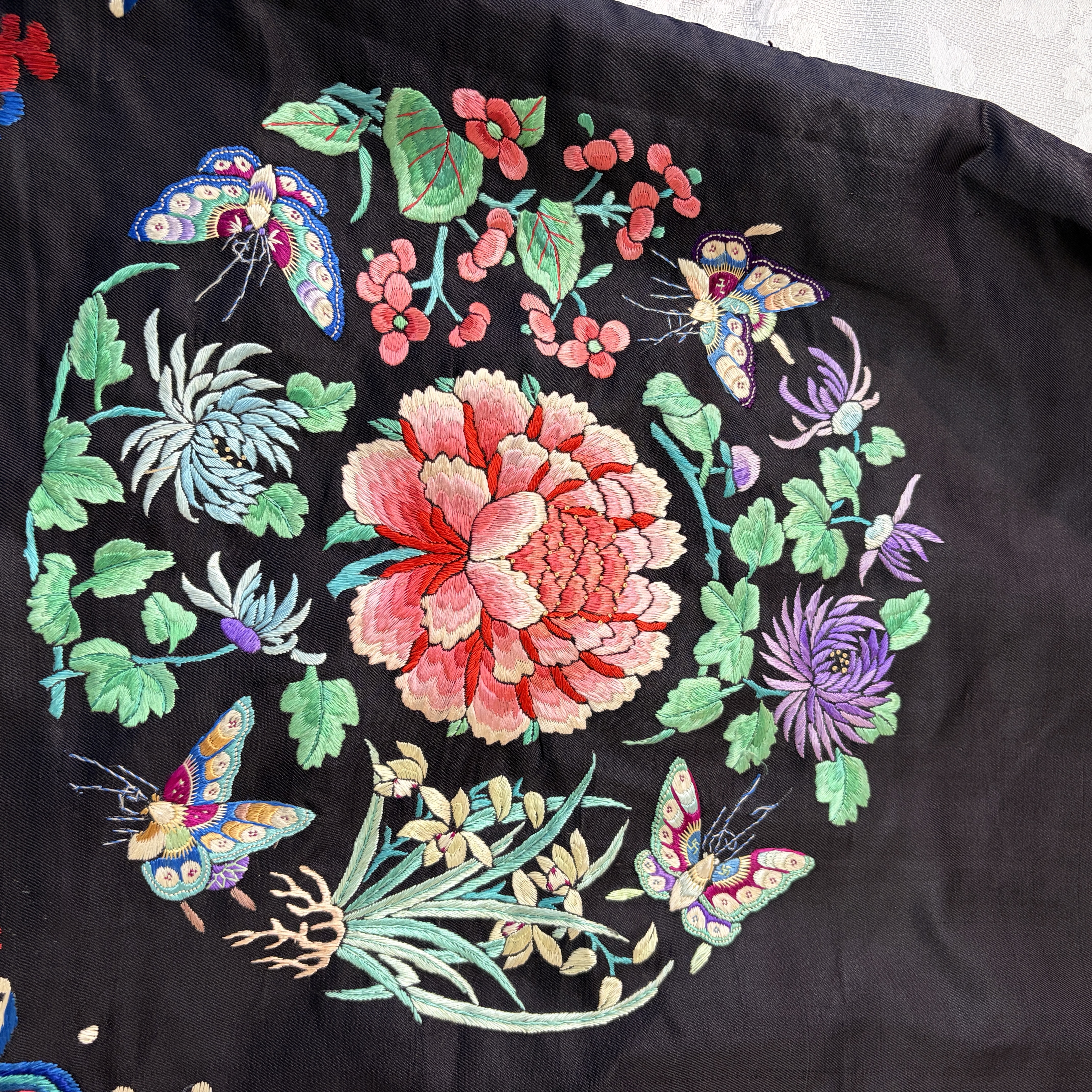 A Chinese embroidered silk dark-blue-ground robe with floral medallions — photo 21
