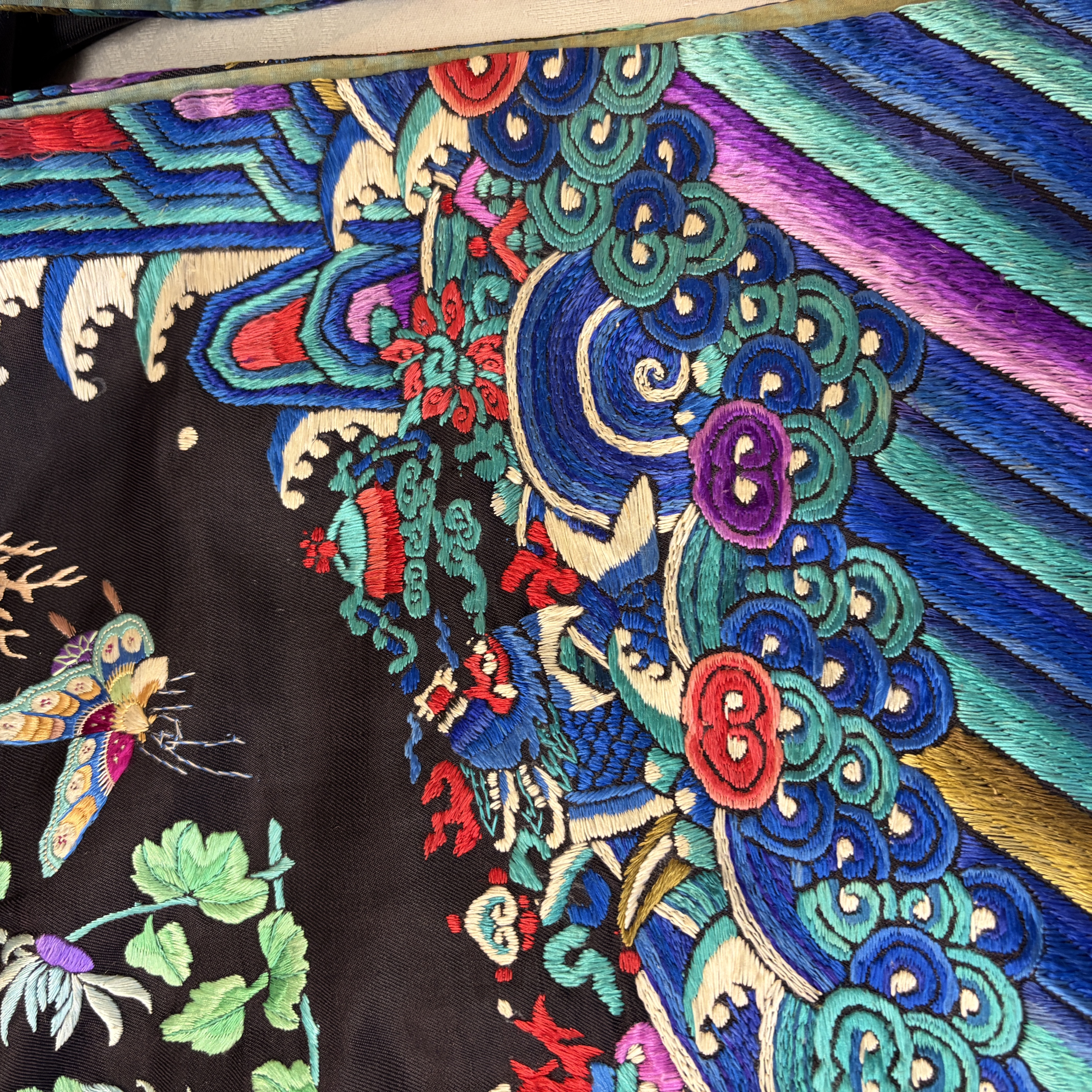 A Chinese embroidered silk dark-blue-ground robe with floral medallions — photo 22