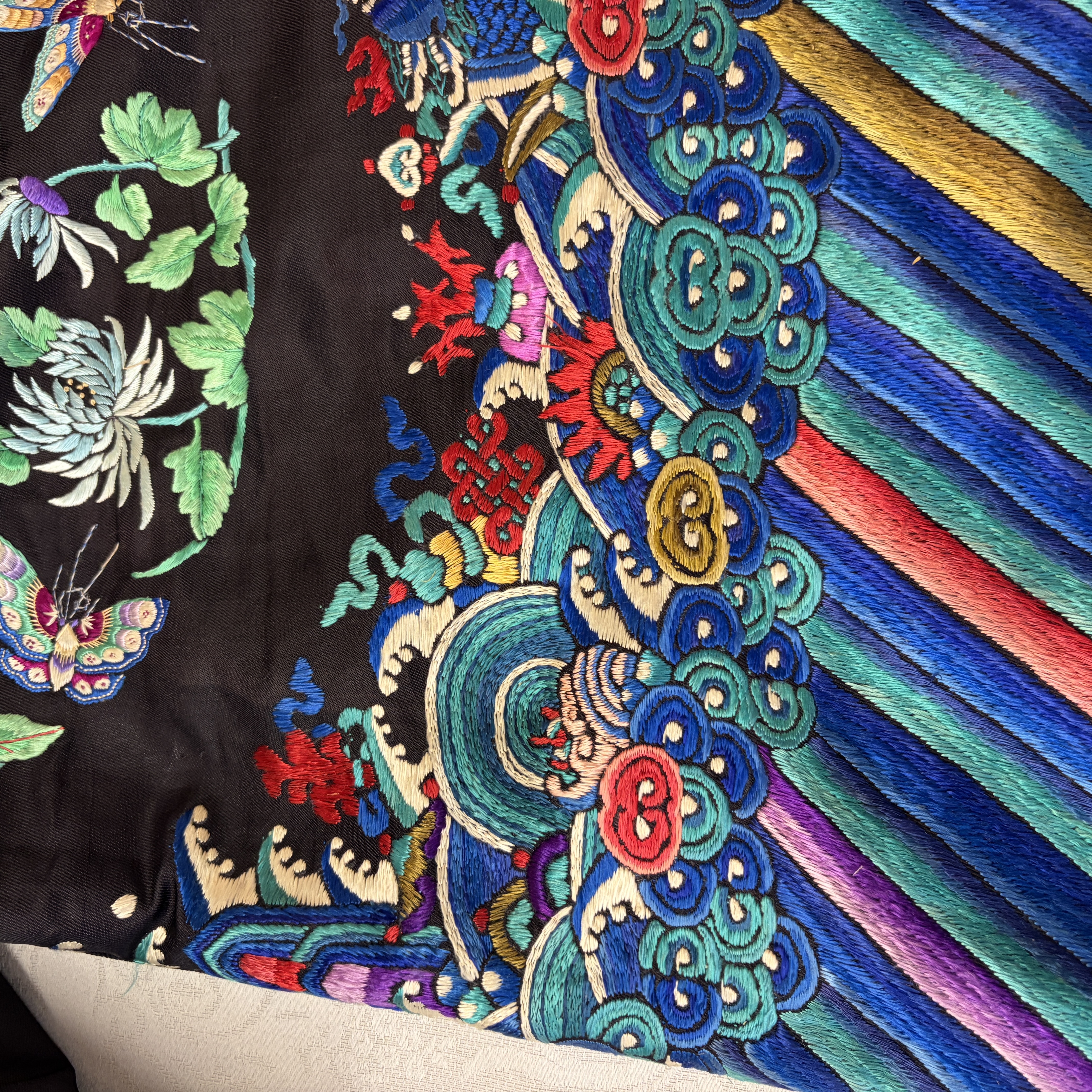 A Chinese embroidered silk dark-blue-ground robe with floral medallions — photo 24