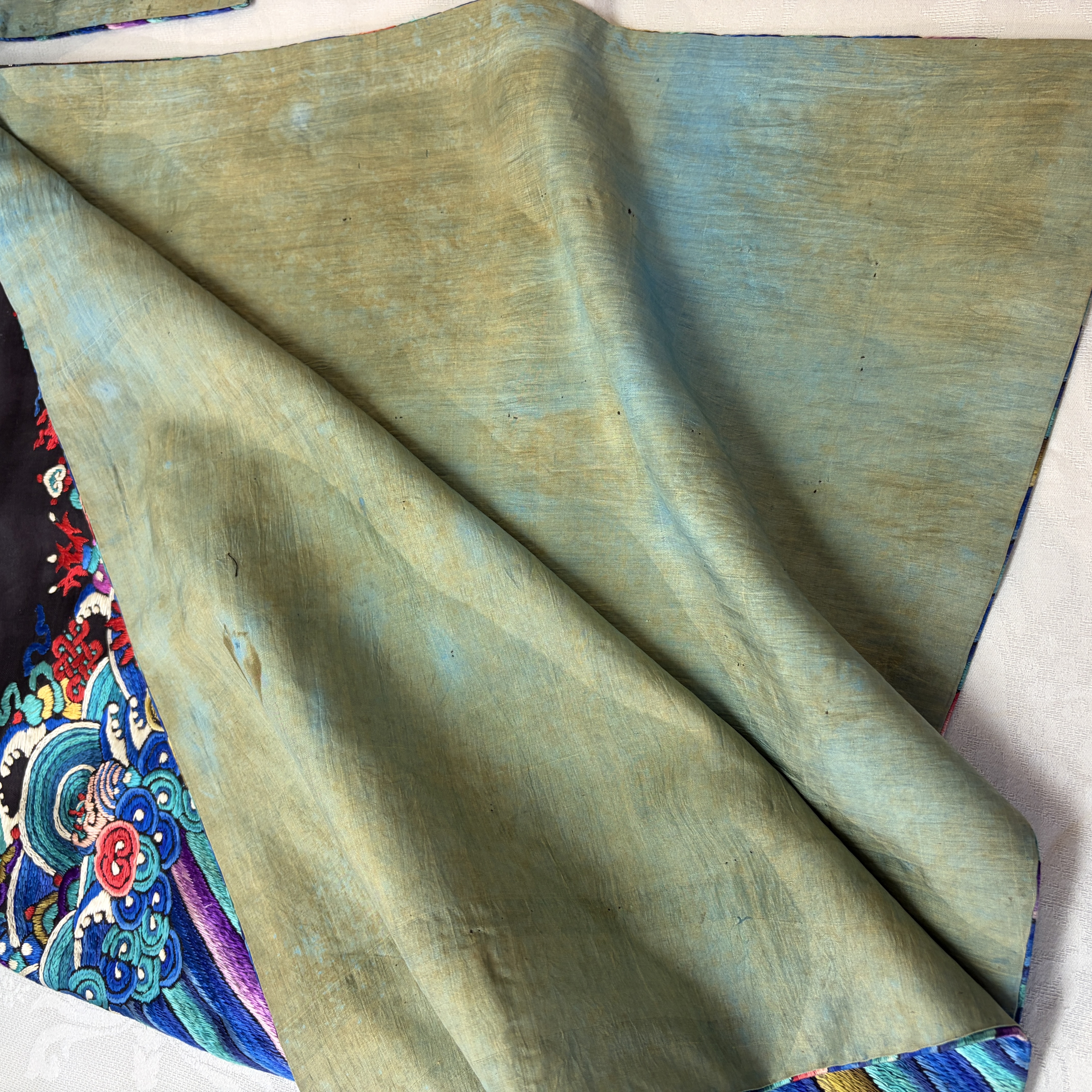 A Chinese embroidered silk dark-blue-ground robe with floral medallions — photo 25