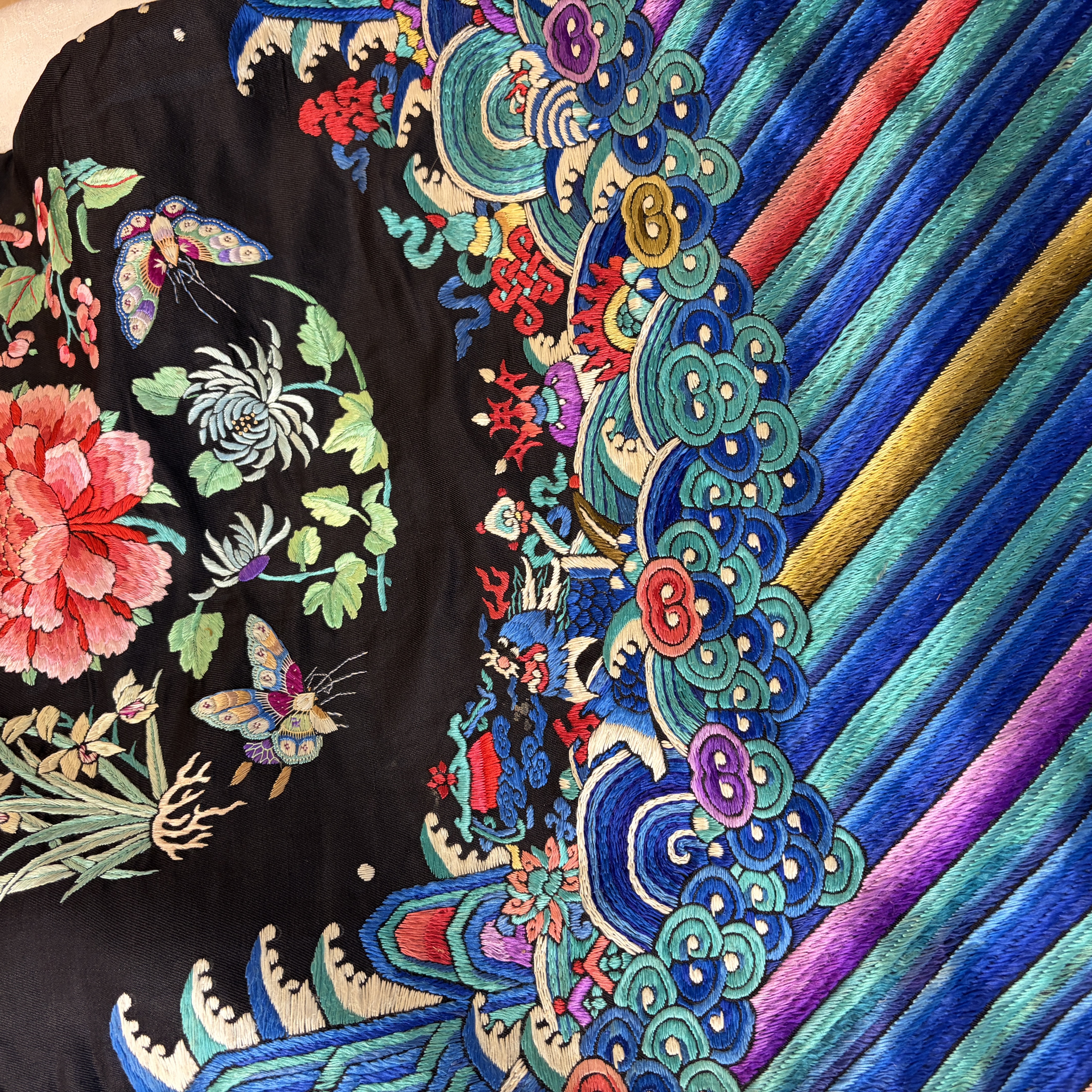 A Chinese embroidered silk dark-blue-ground robe with floral medallions — photo 27
