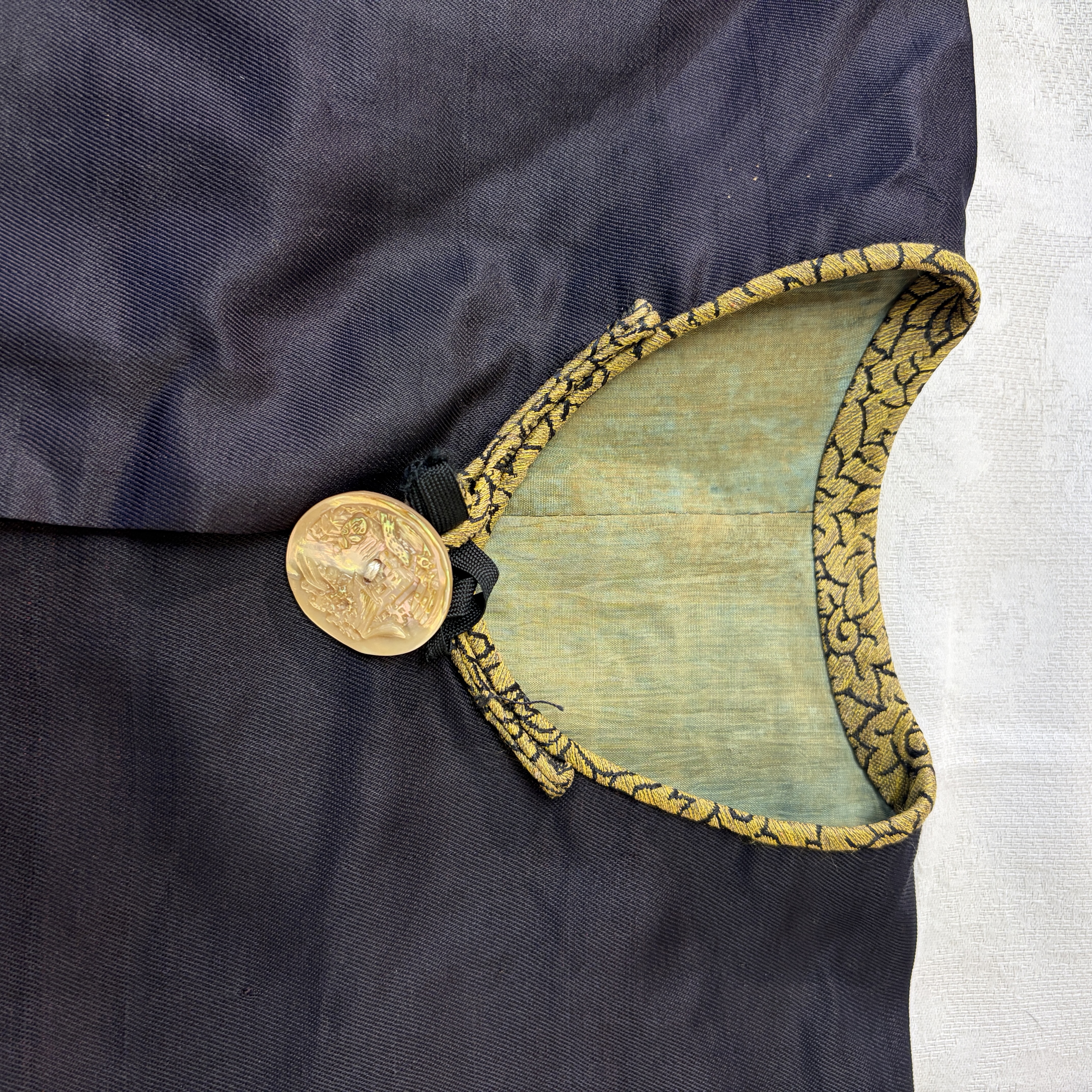A Chinese embroidered silk dark-blue-ground robe with floral medallions — photo 1