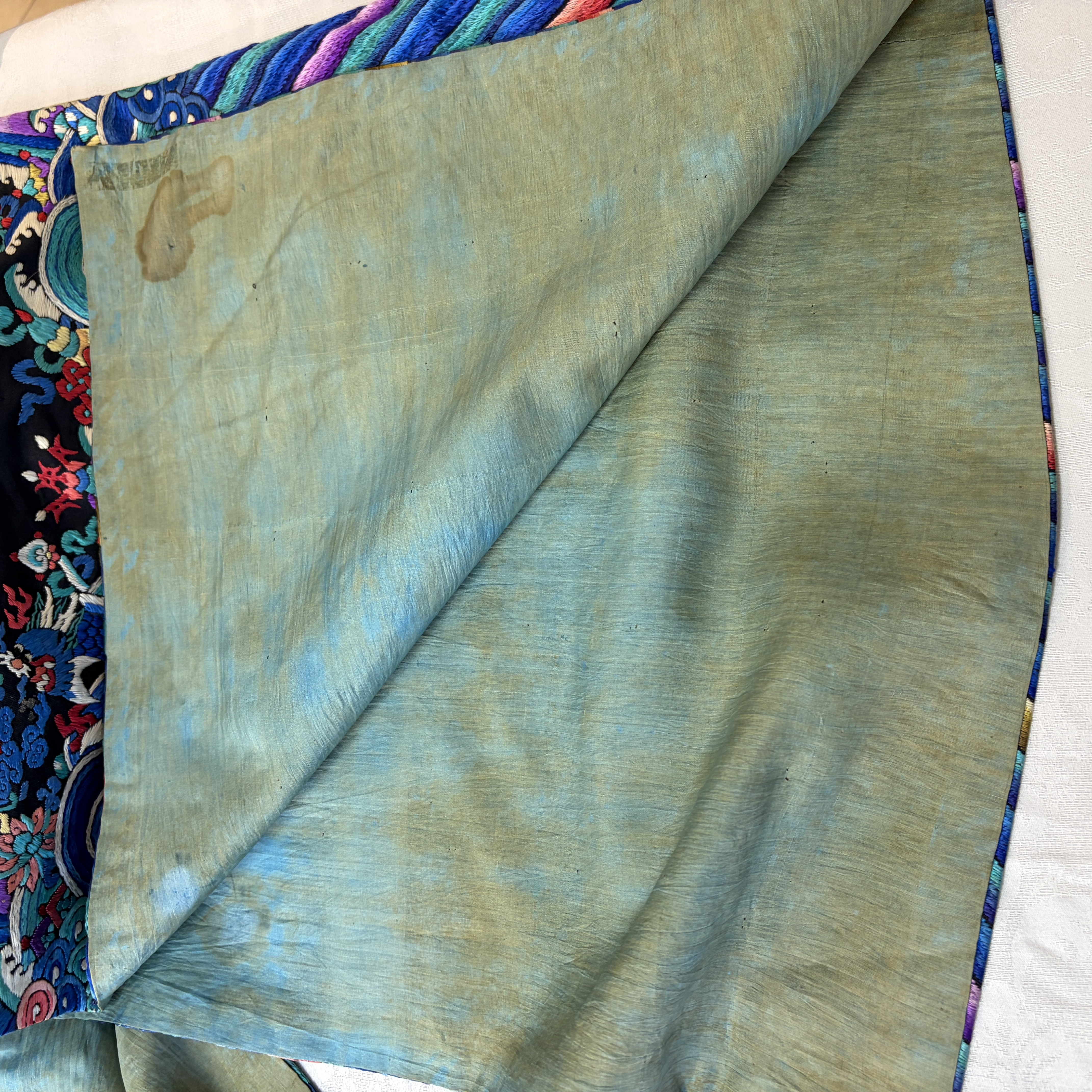 A Chinese embroidered silk dark-blue-ground robe with floral medallions — photo 29