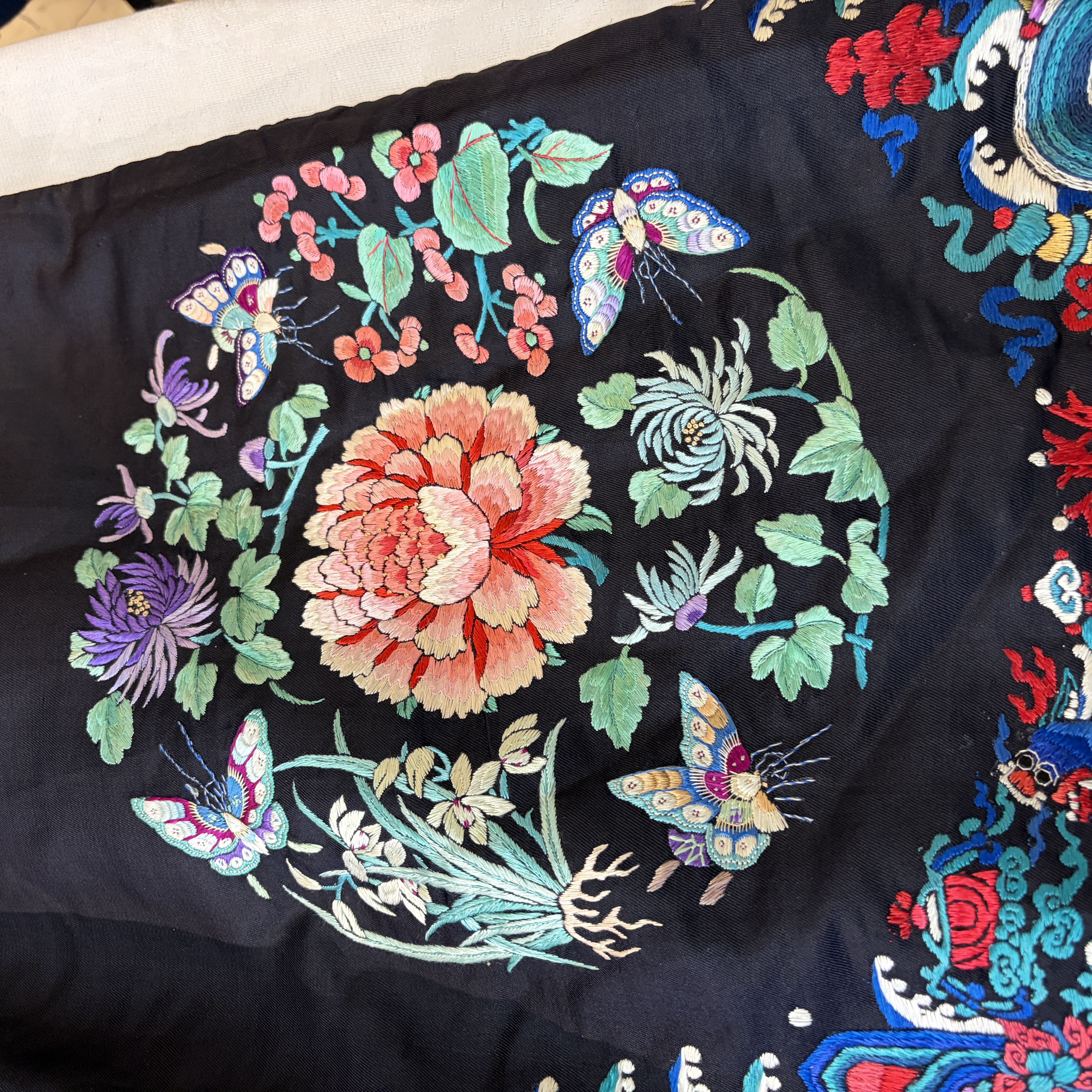 A Chinese embroidered silk dark-blue-ground robe with floral medallions — photo 33
