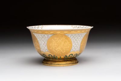 A Chinese European-decorated gilt bronze-mounted blue and white reticulated bowl, Transitional period