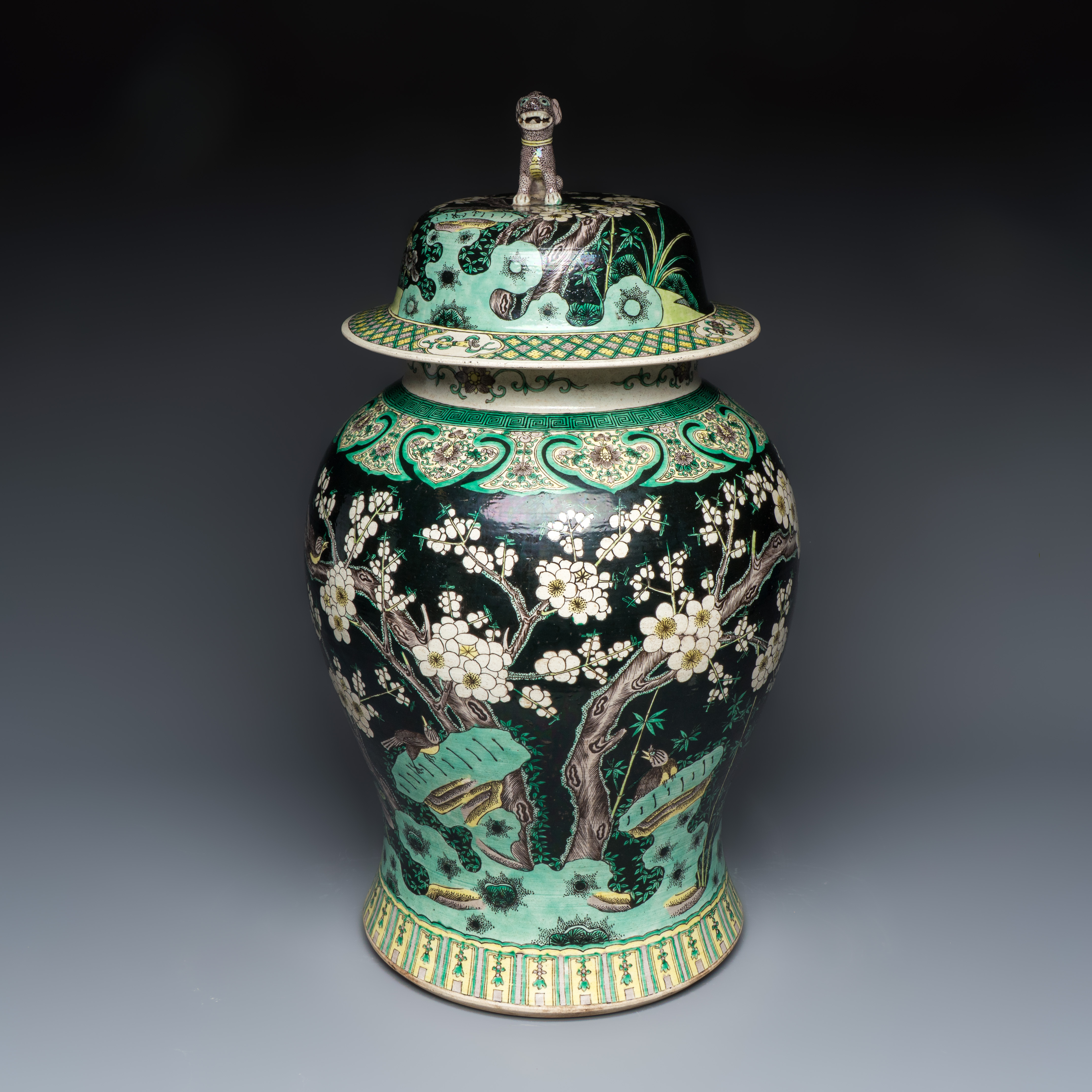 A Chinese famille noire 'Prunus' vase and cover, 19th C.