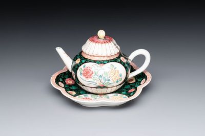 A Chinese famille rose black-ground teapot and stand with floral design, Yongzheng/Qianlong