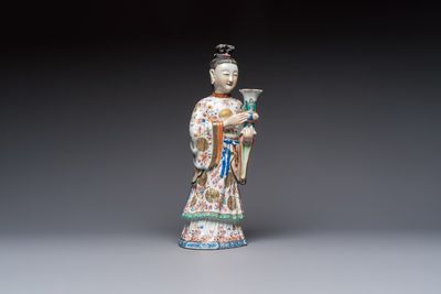 A Chinese famille rose candle holder in the shape of a court lady holding a 'Gu' vase, Qianlong