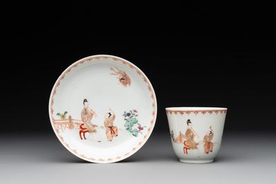 A Chinese famille rose cup and saucer with a lady playing flute, a boy and a phoenix, Qianlong