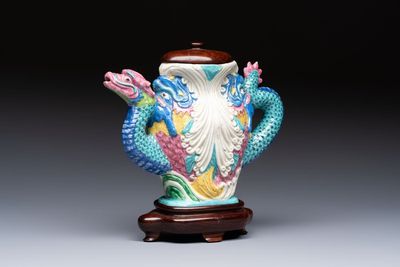A Chinese famille rose ewer in the form of a dragon and two carps with wooden cover and stand, 19th C.