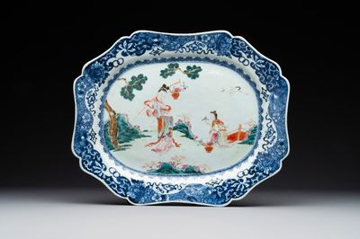 A Chinese famille rose 'He Xiangu' charger with a blue and white border, Qianlong