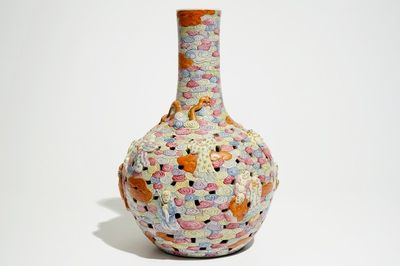 A Chinese famille rose reticulated bottle vase with figures, 19th C.