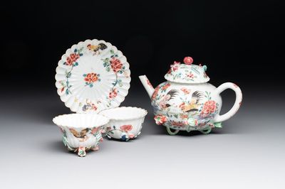 A Chinese famille rose 'rooster' teapot with applied floral design, two cups and a saucer, Yongzheng/Qianlong