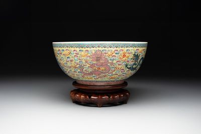 A Chinese famille rose turquoise-and-yellow-ground 'dragon' bowl on wooden stand, Qianlong mark, Republic