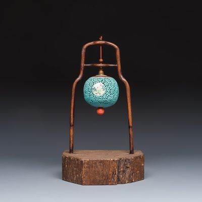 A Chinese famille rose turquoise-ground reticulated incense ball and cover, and a wooden stand, Qianlong