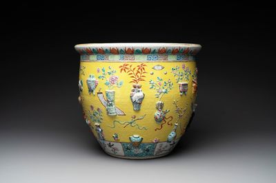 A Chinese famille rose yellow-ground relief-molded 'antiquities' fish bowl, Zhengde mark, 19th C.