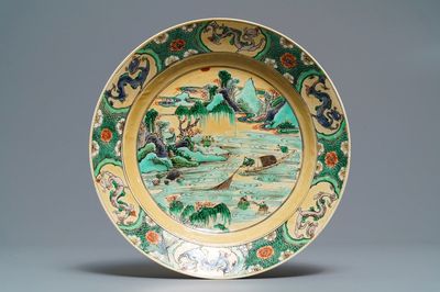 A Chinese famille verte café-au-lait ground plate with fishermen, Kangxi