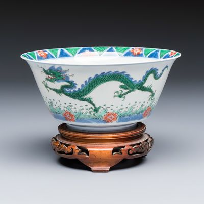 A Chinese famille verte 'Dragon' bowl on a later wooden stand, Kangxi mark and of the period