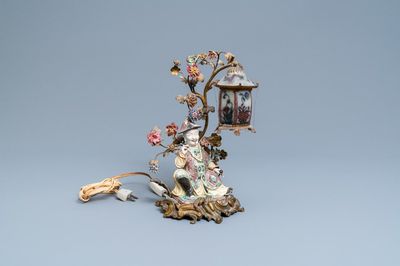 A Chinese famille verte figure mounted into a lamp with gilt bronze, glass and Samson porcelain, 19th C.