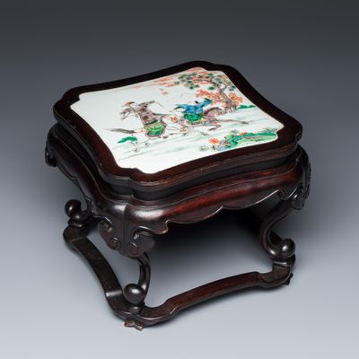 A Chinese famille verte 'Horseriders' plaque set in a hongmu square stand, Kangxi seal mark, 19th C.