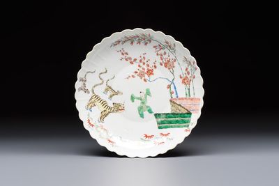 A Chinese famille verte Kakiemon-style 'Boy and Tigers' lobed dish, Kangxi