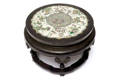 A Chinese famille verte on biscuit lotus-shaped dragon plaque mounted in a wooden stand, Kangxi