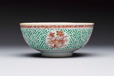 A Chinese famille verte relief-carved bowl with gilt iron-red floral design, Kangxi
