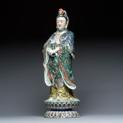 A Chinese famille verte standing Guanyin on a lotus throne, 19th C.