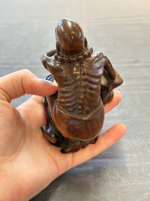 A Chinese fine huanghuali sculpture of a Luohan on a zitan stand, Qianlong mark, 19/20th C. — photo 9