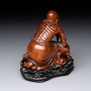 A Chinese fine huanghuali sculpture of a Luohan on a zitan stand, Qianlong mark, 19/20th C. — photo 2