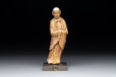 A Chinese gilt and polychromed stucco figure of a monk, Ming