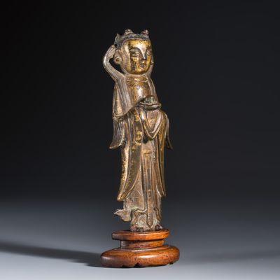A Chinese gilt-bronze figure of Longnu on a wooden stand, Ming