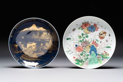 A Chinese gilt-decorated powder-blue plate and a famille verte plate with flowers, Kangxi/Qianlong